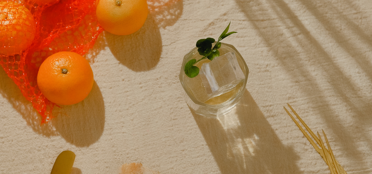 Minimal aesthetic table top view with oranges and drink.